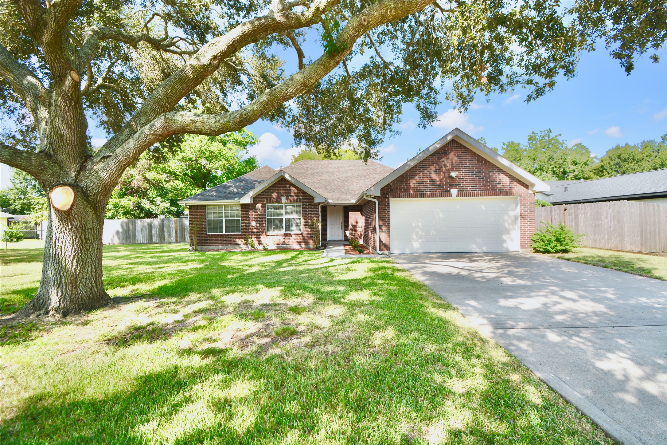a front view of a house with yard and green space