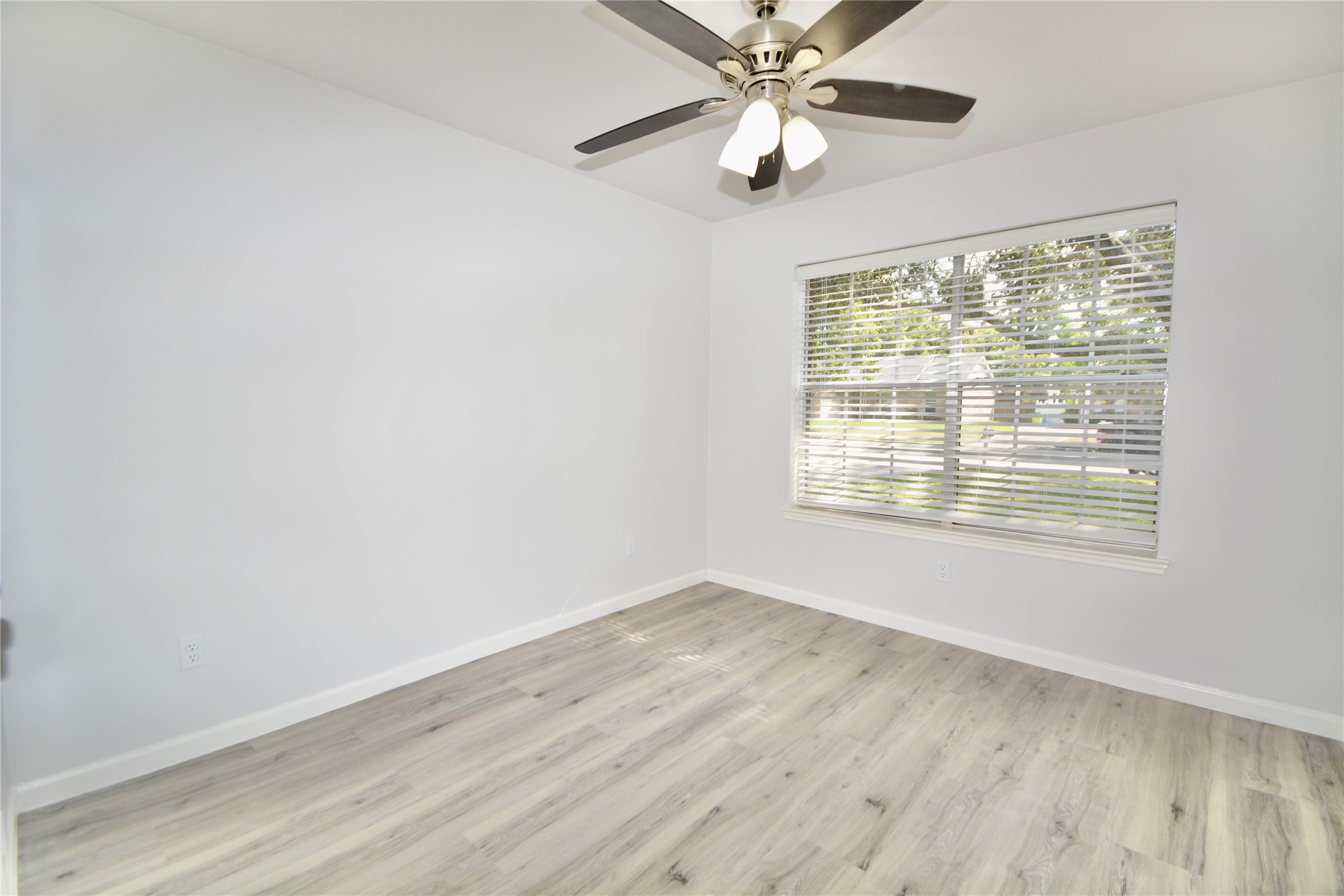 2020 Ward Street Rosenberg, TX 77471 - Photo 13 of 19 a view of an empty room with wooden floor and a window