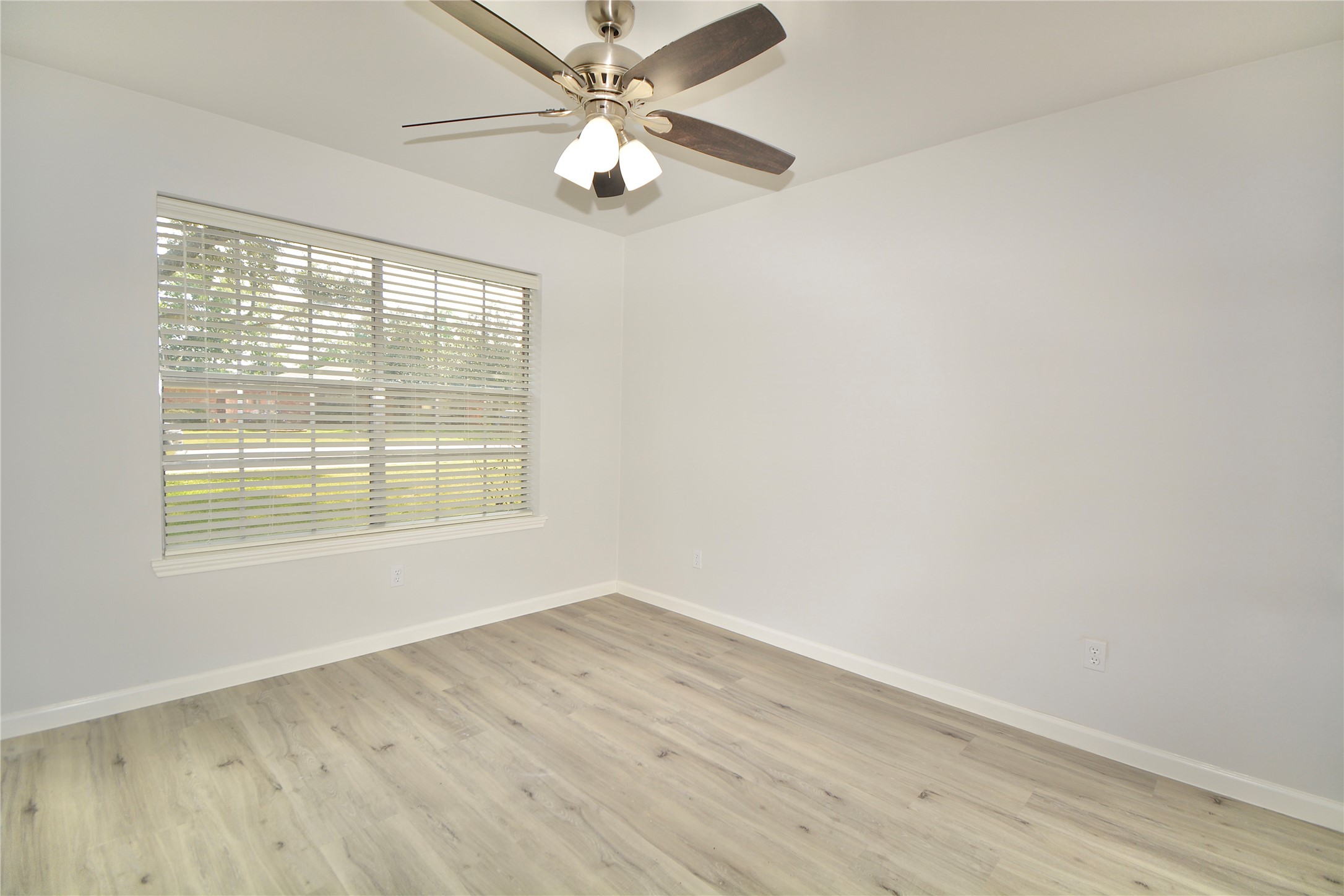 2020 Ward Street Rosenberg, TX 77471 - Photo 15 of 19 an empty room with wooden floor fan and windows