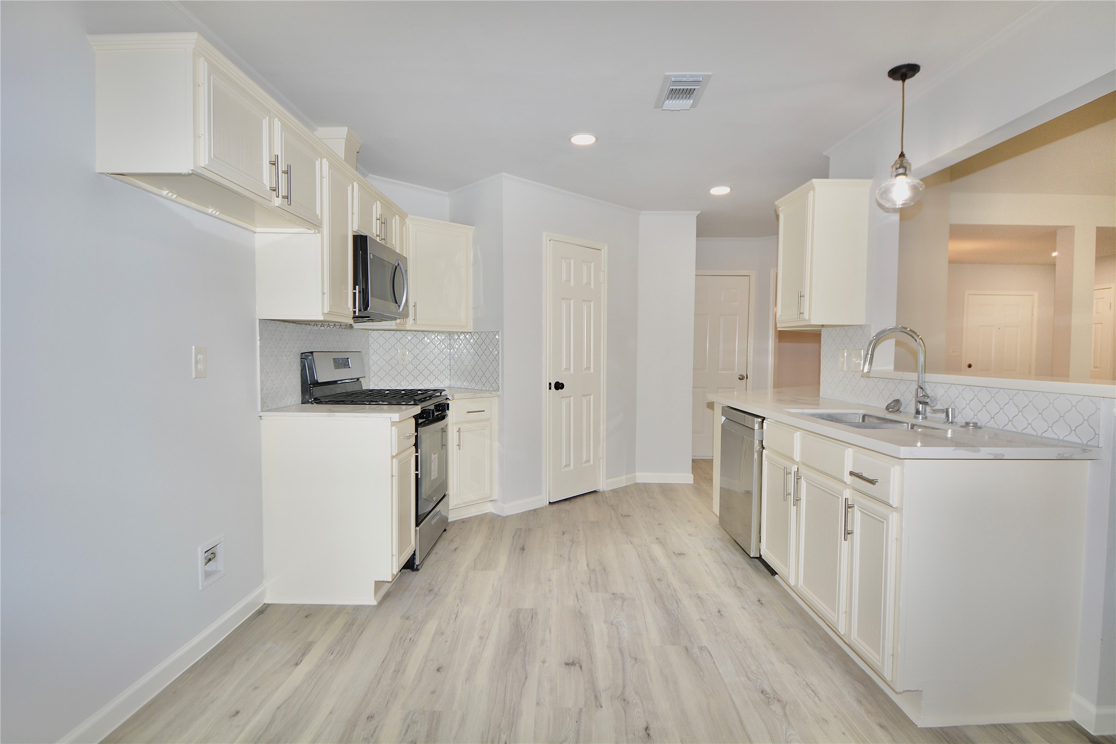 2020 Ward Street Rosenberg, TX 77471 - Photo 3 of 19 a large kitchen with a lot of counter space and wooden floor