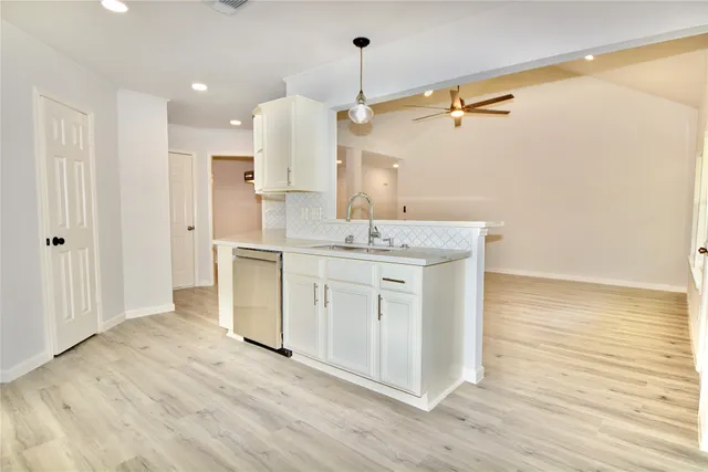 a view of cabinets a sink with wooden floor