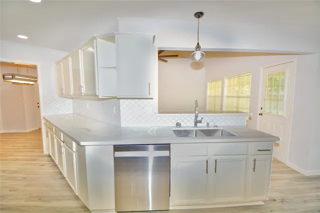 a kitchen with a sink cabinets and window