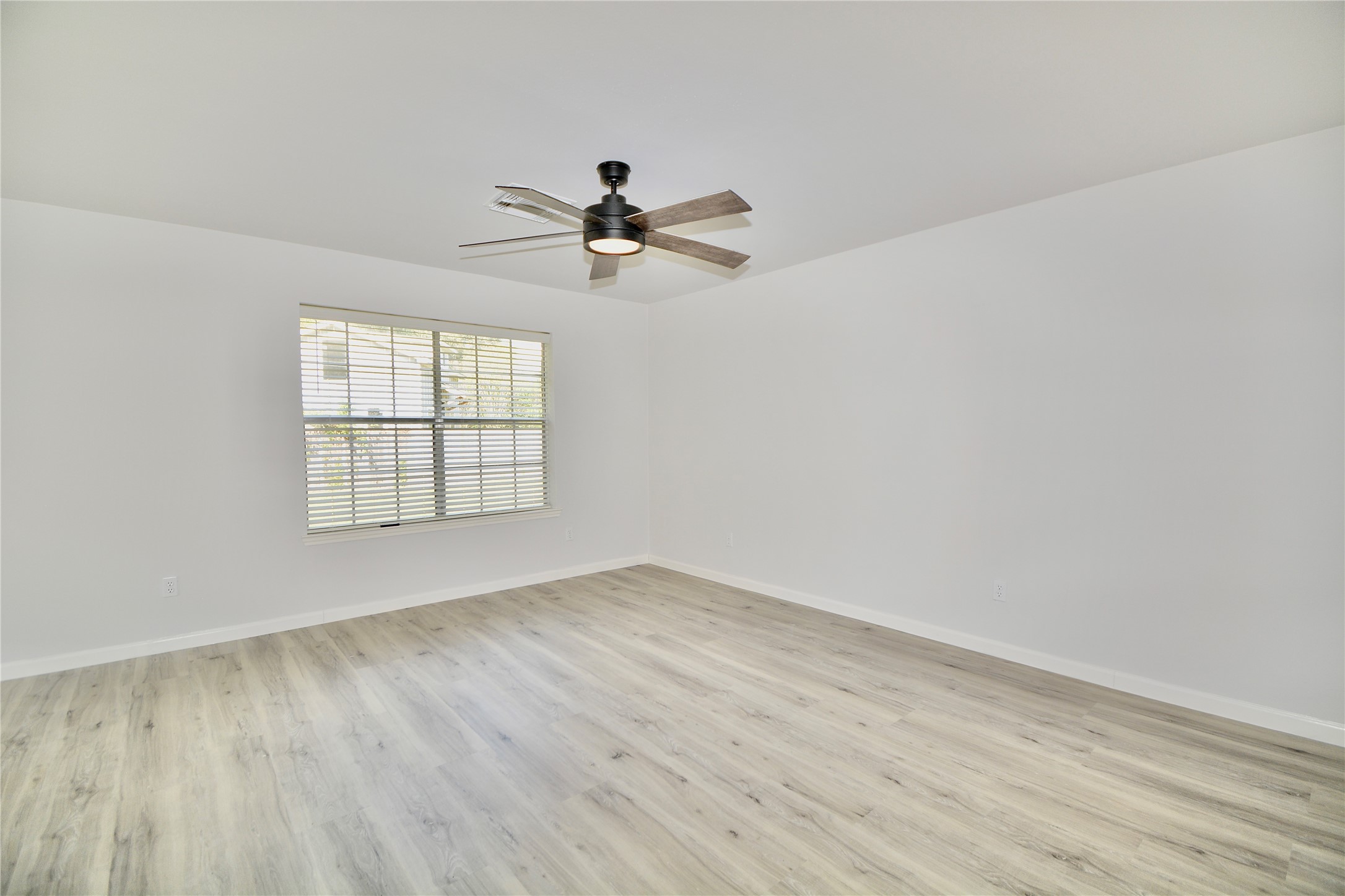 2020 Ward Street Rosenberg, TX 77471 - Photo 8 of 19 an empty room with wooden floor fan and windows