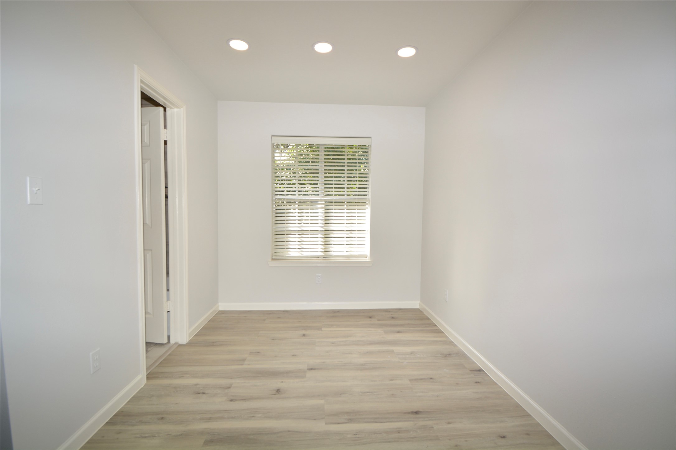 2020 Ward Street Rosenberg, TX 77471 - Photo 9 of 19 a view of an empty room with wooden floor and a window