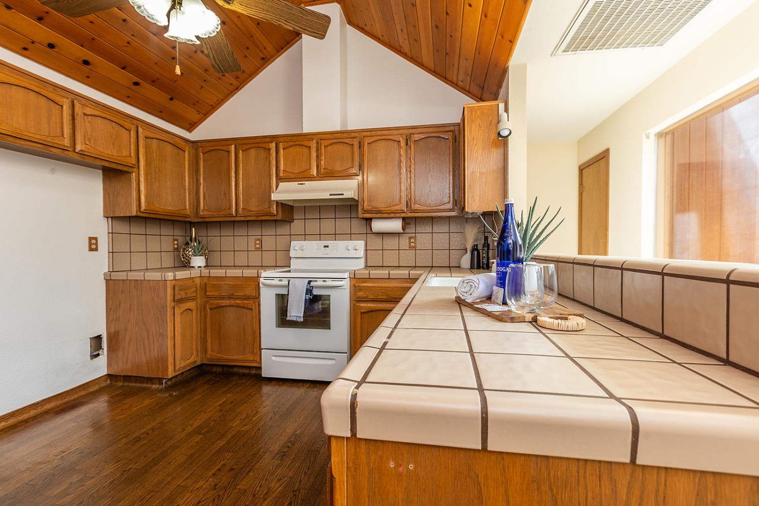 3913 Cougar Place Modesto, CA 95356 - Photo 15 of 40 a kitchen with a sink a stove and cabinets
