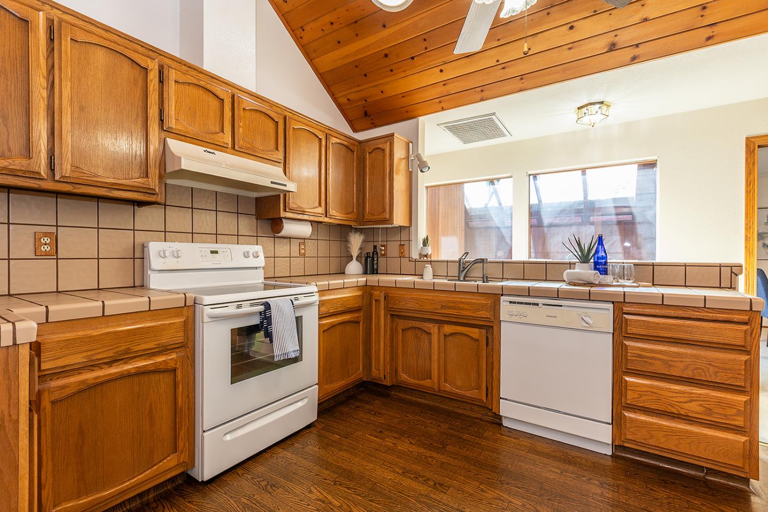3913 Cougar Place Modesto, CA 95356 - Photo 16 of 40 a kitchen with stainless steel appliances granite countertop a stove a sink and white cabinets