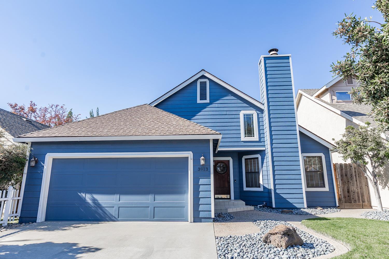 3913 Cougar Place Modesto, CA 95356 - Photo 3 of 40 a front view of a house with a yard