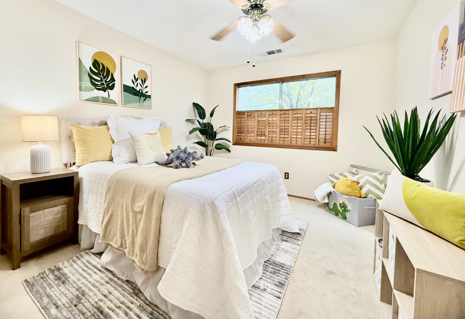 3913 Cougar Place Modesto, CA 95356 - Photo 34 of 40 a bedroom with a bed a chandelier and potted plant on the dresser