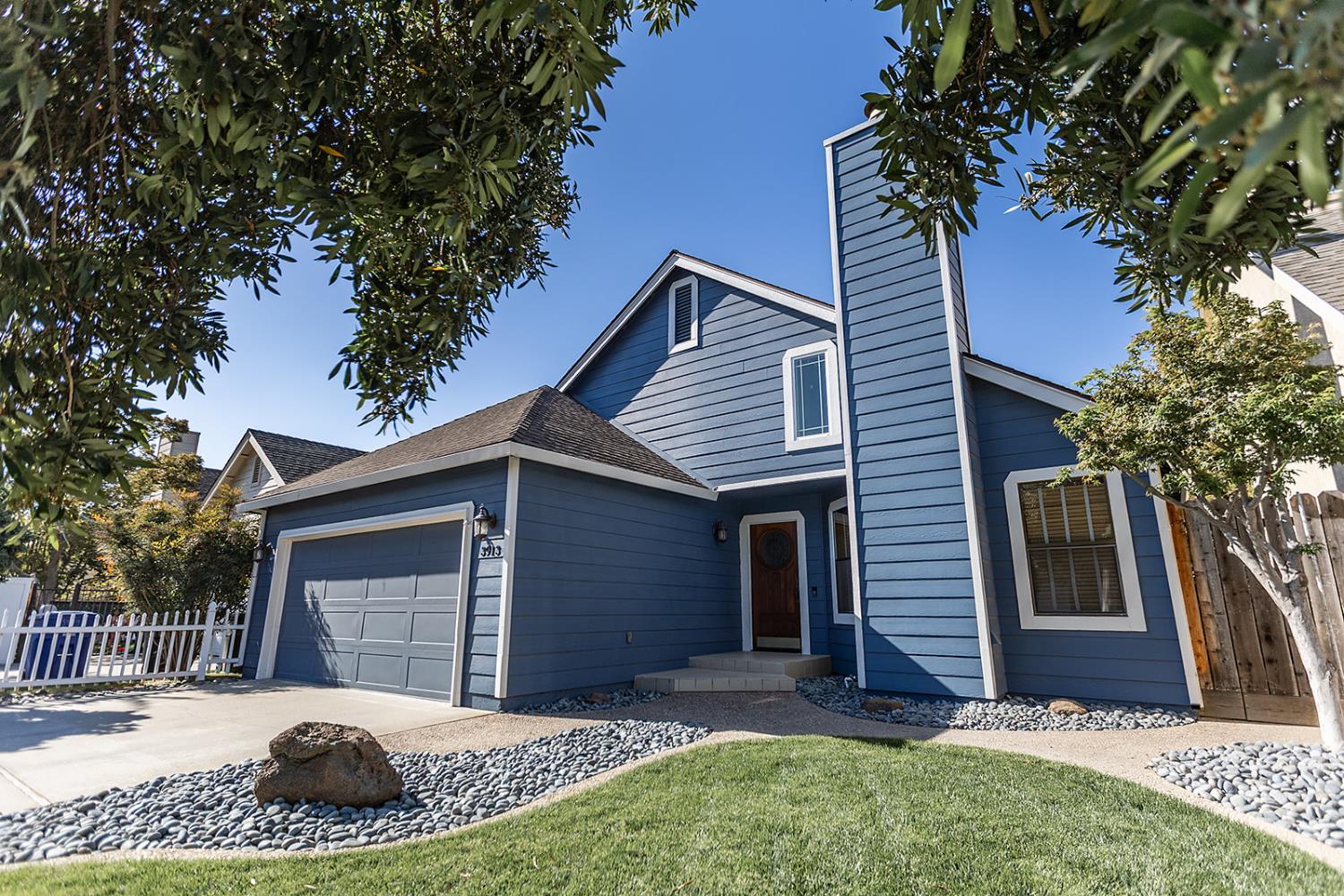 3913 Cougar Place Modesto, CA 95356 - Photo 4 of 40 a view of a house with a yard and garage