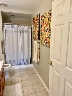 a view of a yard with plants and large trees