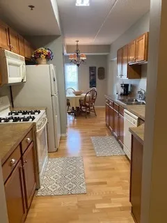 a kitchen with refrigerator and cabinets