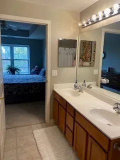 a bathroom with a sink double vanity and a mirror