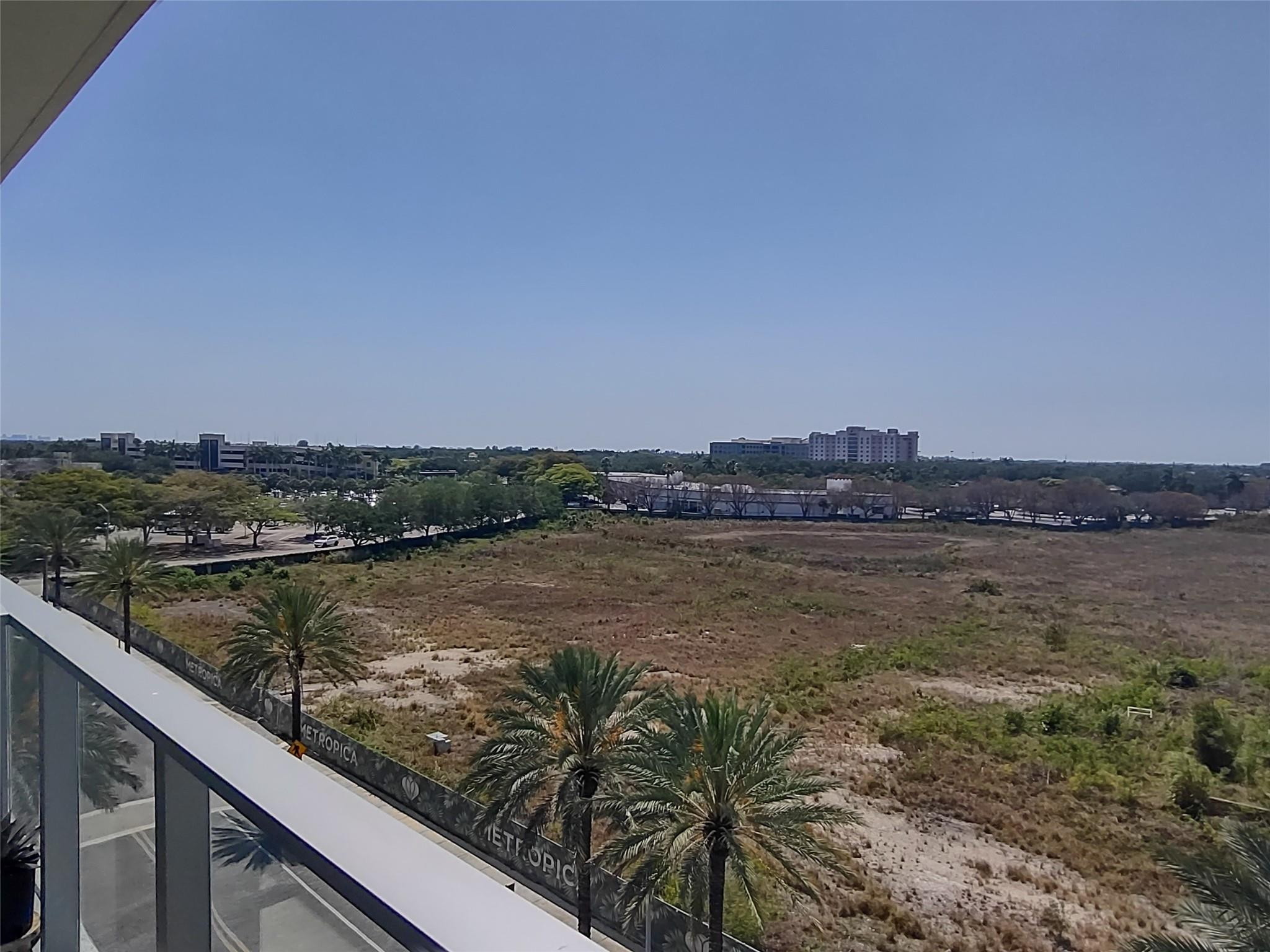 2000 Metropica Way, Unit 507 Sunrise, FL 33323 - Photo 3 of 13 a view of a lake from a balcony
