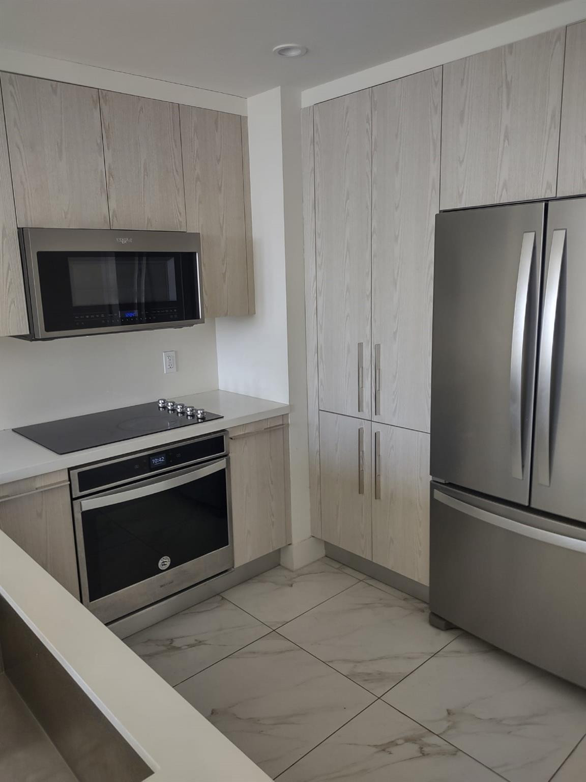2000 Metropica Way, Unit 507 Sunrise, FL 33323 - Photo 5 of 13 a kitchen with a refrigerator stove and microwave