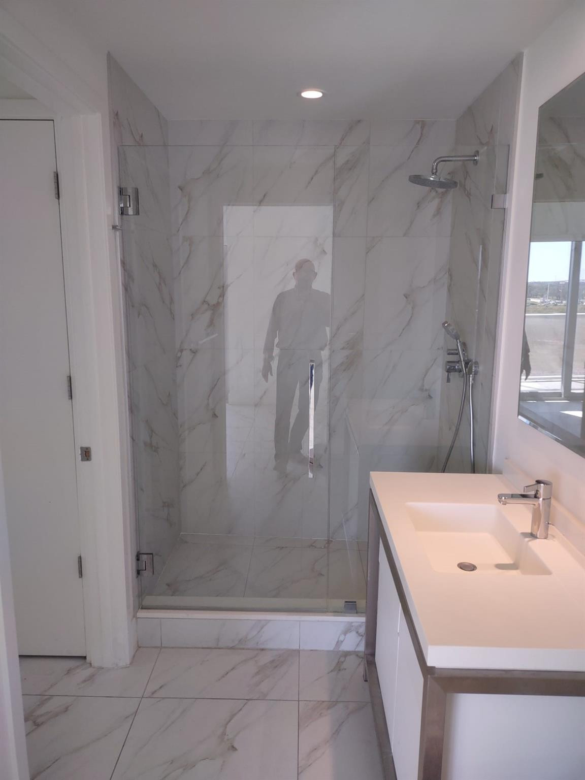 2000 Metropica Way, Unit 507 Sunrise, FL 33323 - Photo 6 of 13 a bathroom with a sink a shower and a mirror