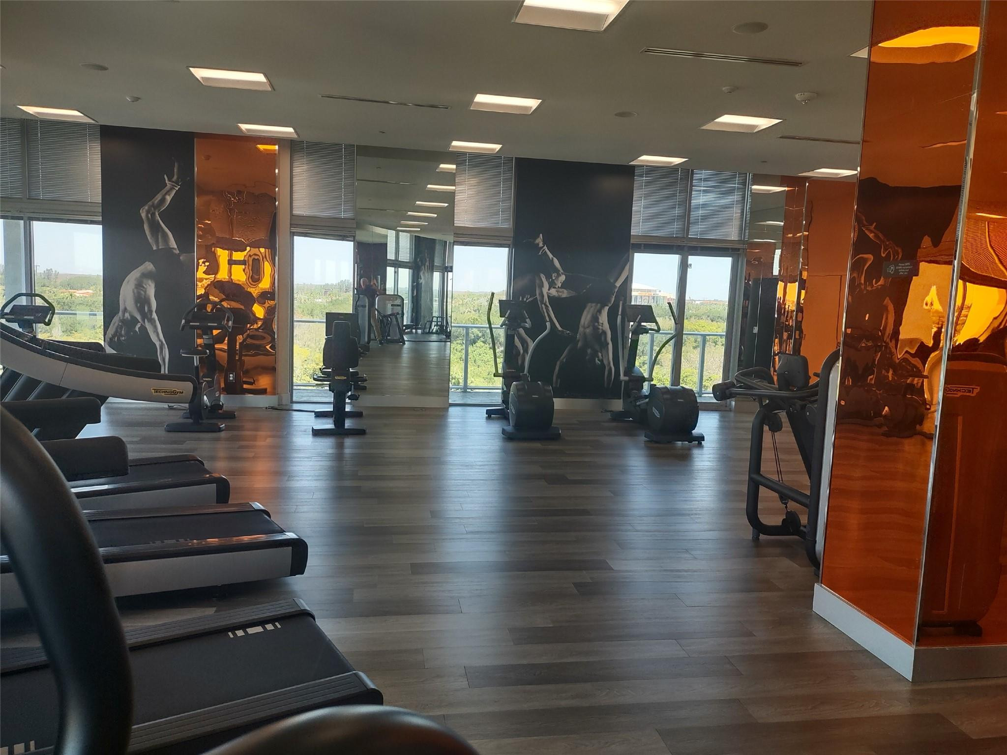 2000 Metropica Way, Unit 507 Sunrise, FL 33323 - Photo 9 of 13 a lobby with furniture and wooden floor