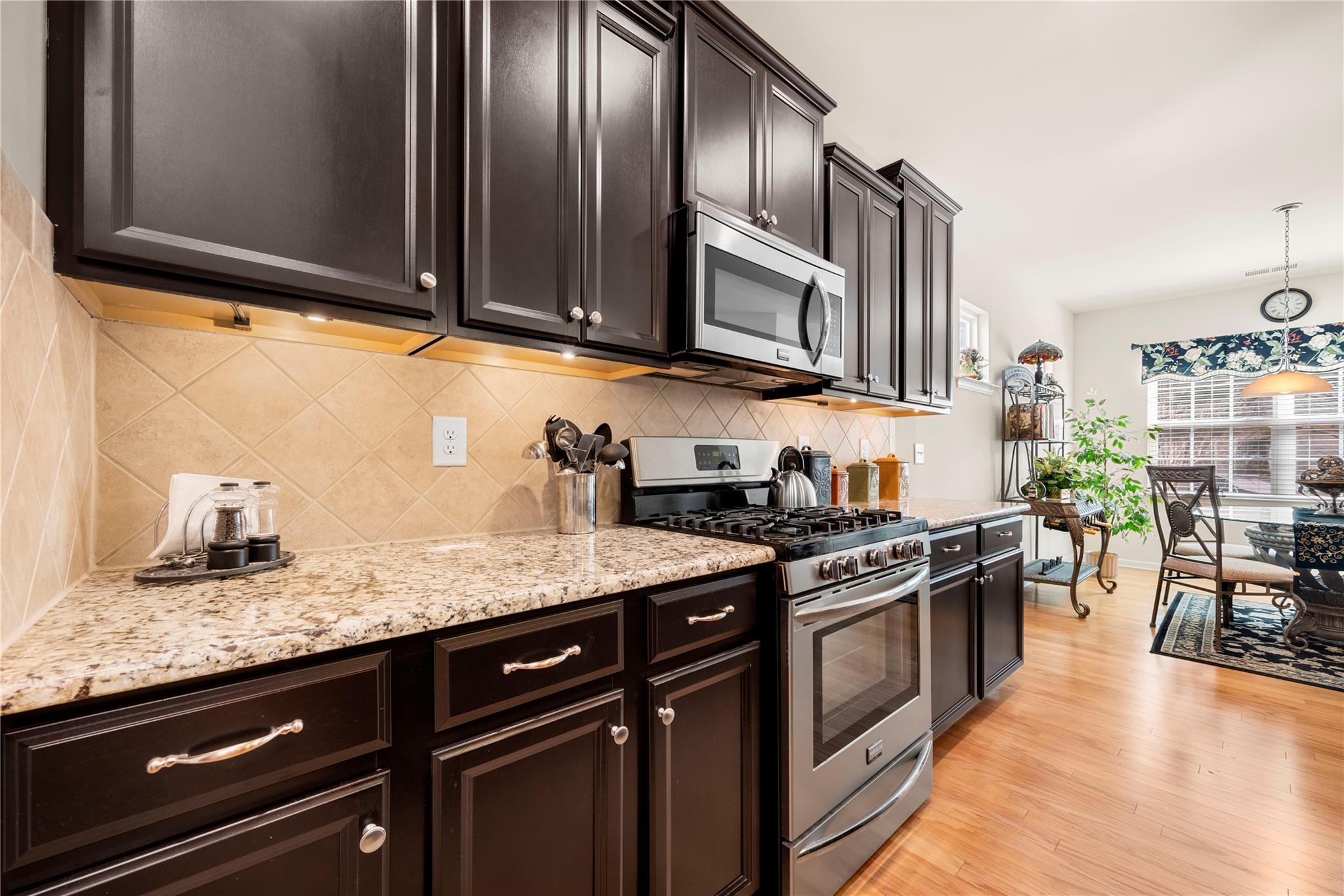 4162 Perth Road Indian Land, SC 29707 - Photo 16 of 47 a kitchen with stainless steel appliances granite countertop a stove a sink and a microwave
