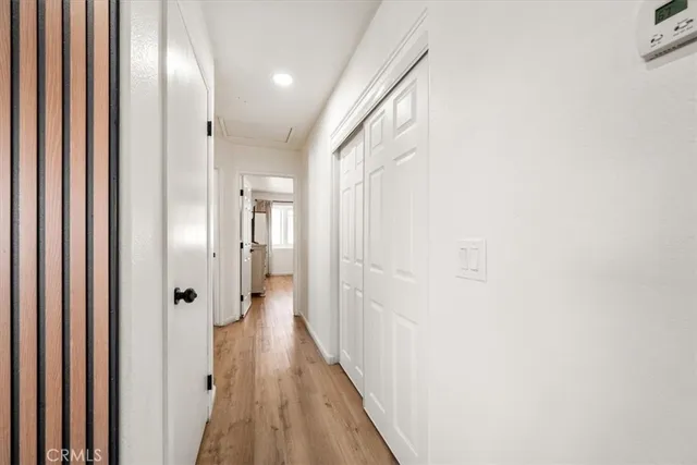 a bedroom with a large bed and a flat tv screen on dresser