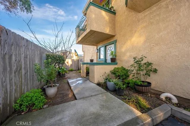 a house with potted plants in front of door