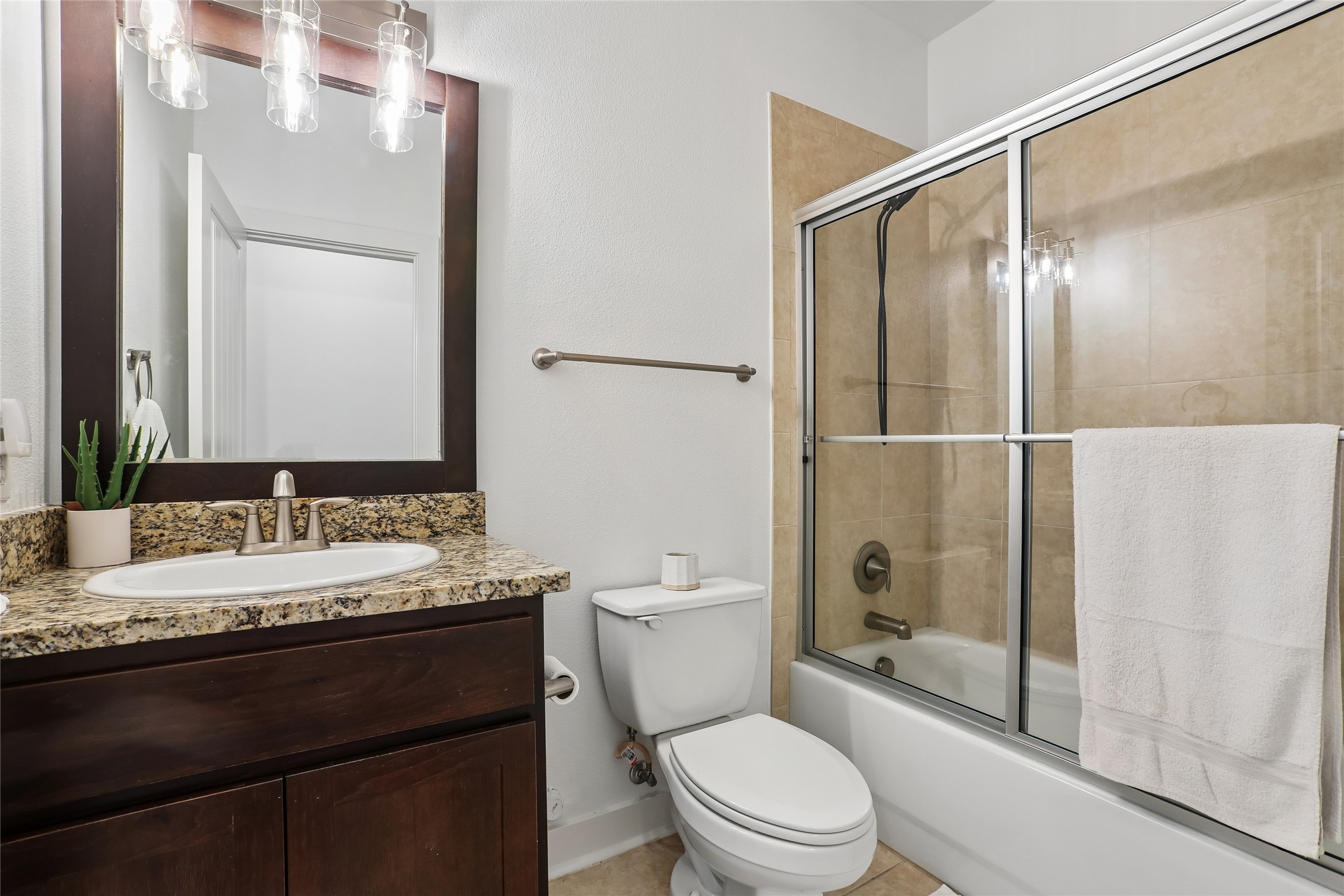 8110 Ranch Road 2222, Unit 10 Austin, TX 78730 - Photo 15 of 23 a bathroom with a granite countertop sink toilet a mirror a vanity and shower