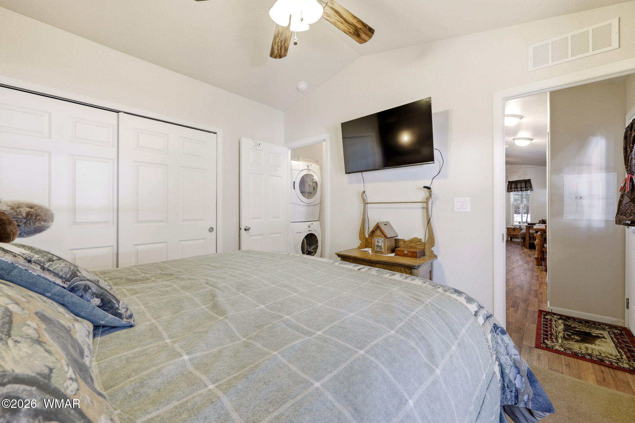 2893 Tracy Road Overgaard, AZ 85933 - Photo 14 of 26 a bedroom with a bed and a flat tv screen on the dresser