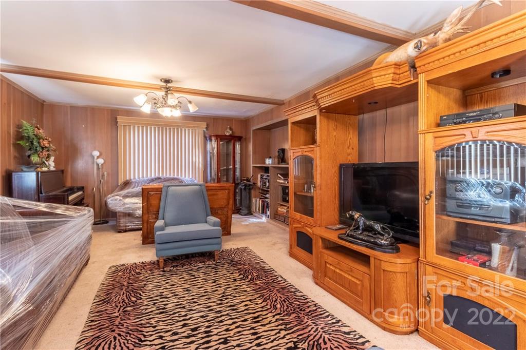 910 Bridlepath Lane Charlotte, NC 28211 - Photo 2 of 5 a living room with furniture and a flat screen tv