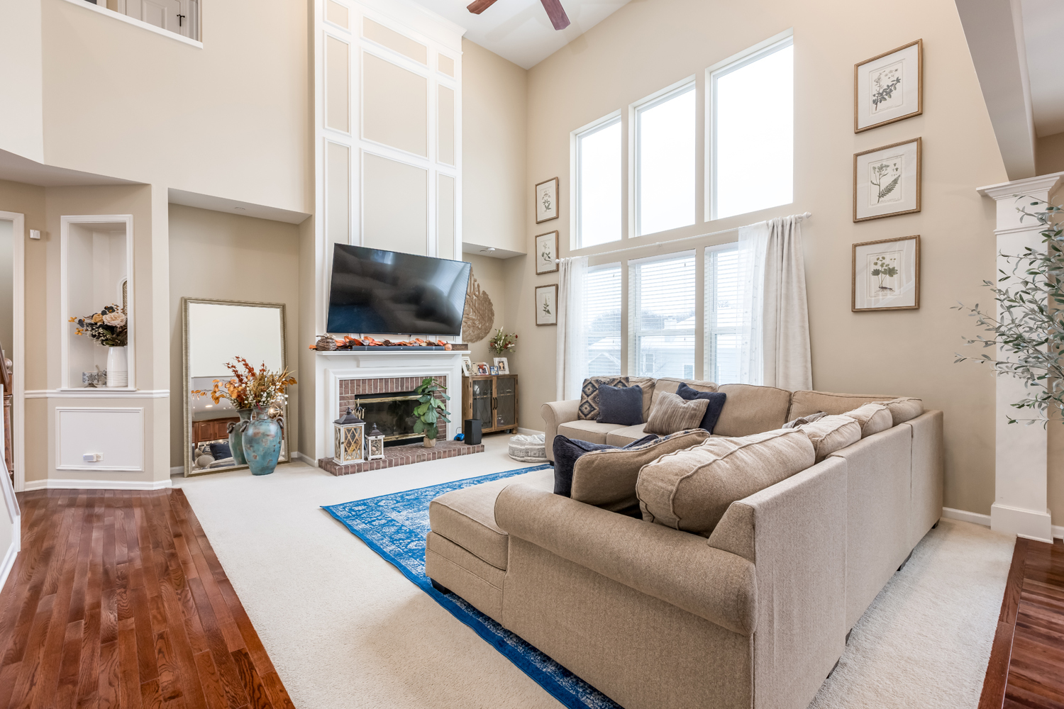 908 Blue Ridge Drive Streamwood, IL 60107 - Photo 11 of 48 a living room with furniture a fireplace and a flat screen tv