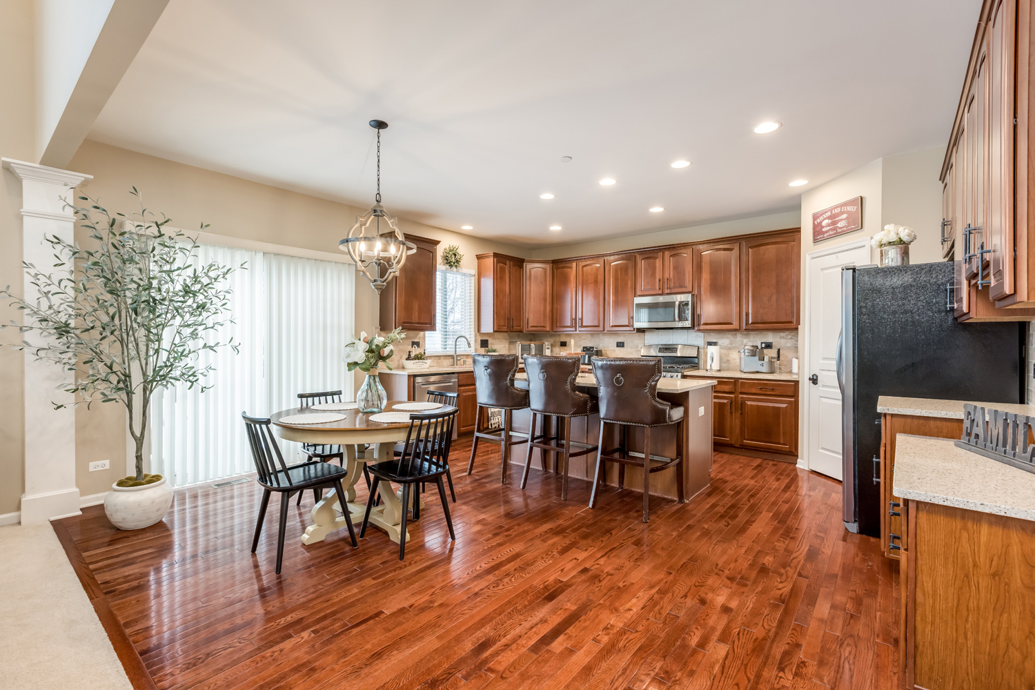 908 Blue Ridge Drive Streamwood, IL 60107 - Photo 12 of 48 a view of a dining room with furniture and wooden floor