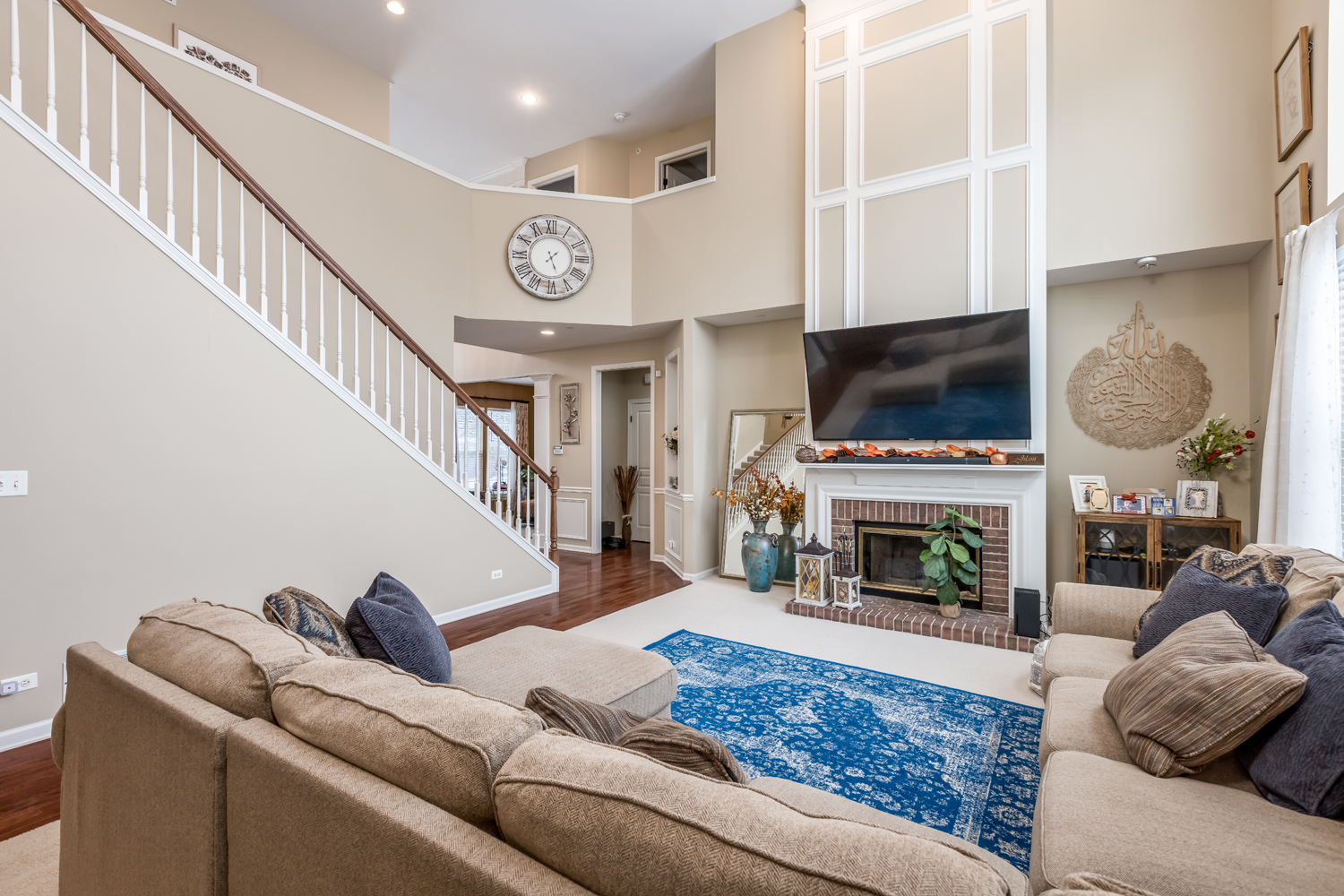 908 Blue Ridge Drive Streamwood, IL 60107 - Photo 18 of 48 a living room with furniture a flat screen tv and a fireplace