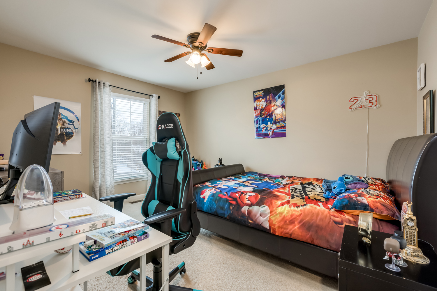 908 Blue Ridge Drive Streamwood, IL 60107 - Photo 20 of 48 a bedroom with a bed and a chandelier