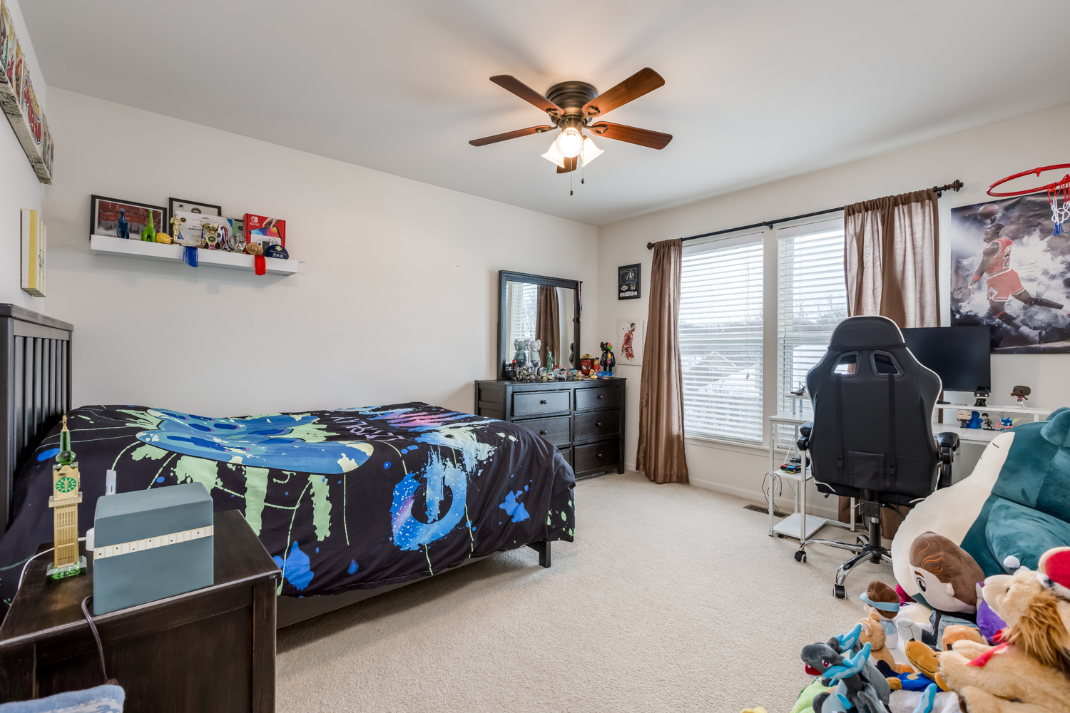 908 Blue Ridge Drive Streamwood, IL 60107 - Photo 23 of 48 a bedroom with a bed and a chandelier