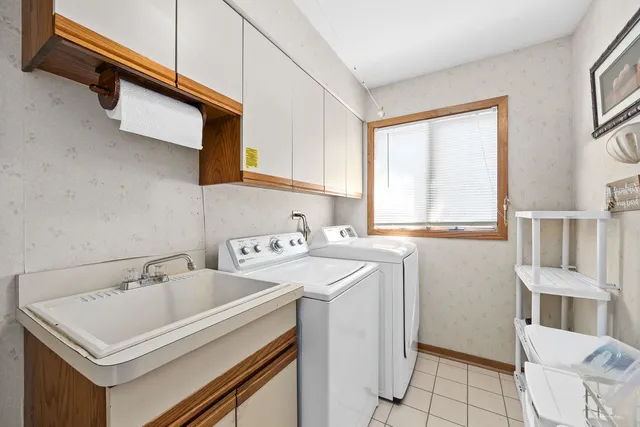 a kitchen with a sink cabinets and window