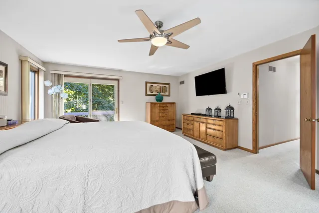 a large white kitchen with a large window