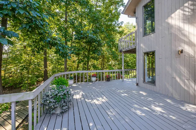 a view of balcony with wooden floor and fence