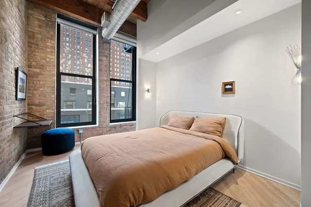 a bedroom with a large bed and a large window