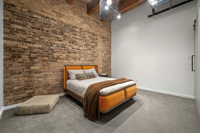 a bedroom with a bed and a night stand