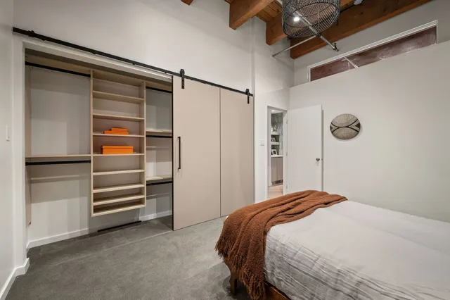 a bedroom with a bed and a walk in closet