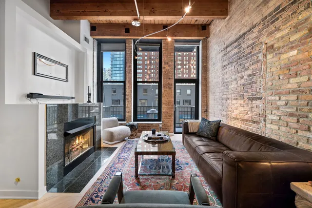 a living room with furniture fireplace and flat screen tv