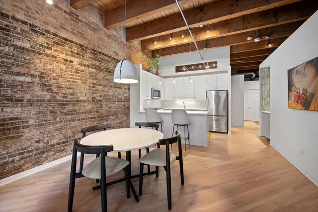 a view of a dining room with furniture and wooden floor
