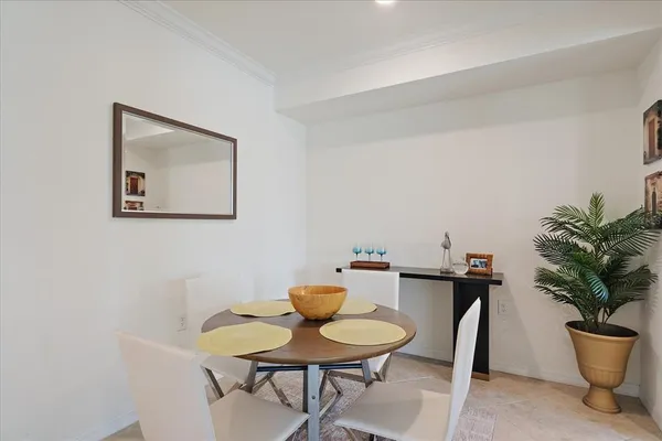 a view of a dining room with furniture and a potted plant