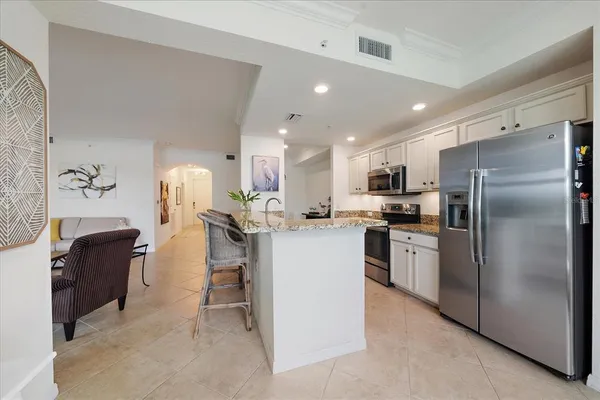 a kitchen with refrigerator and microwave