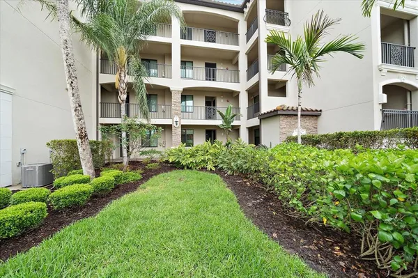 a front view of multi story residential apartment building with a yard