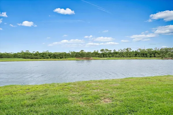 a view of a lake with houses in the back