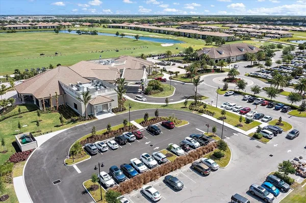 an aerial view of ocean and residential houses with outdoor space