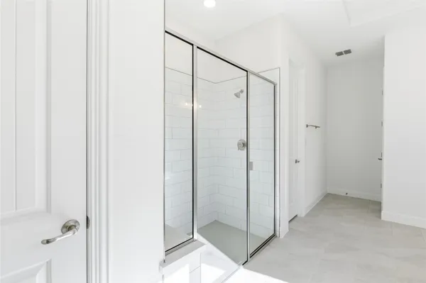 a bathroom with a glass shower door