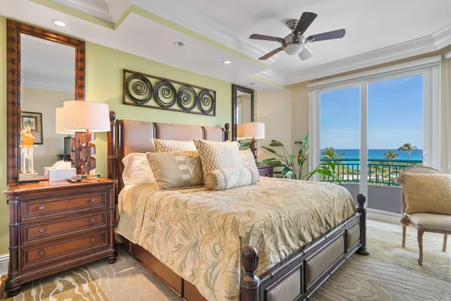 a bed room with furniture and floor to ceiling window