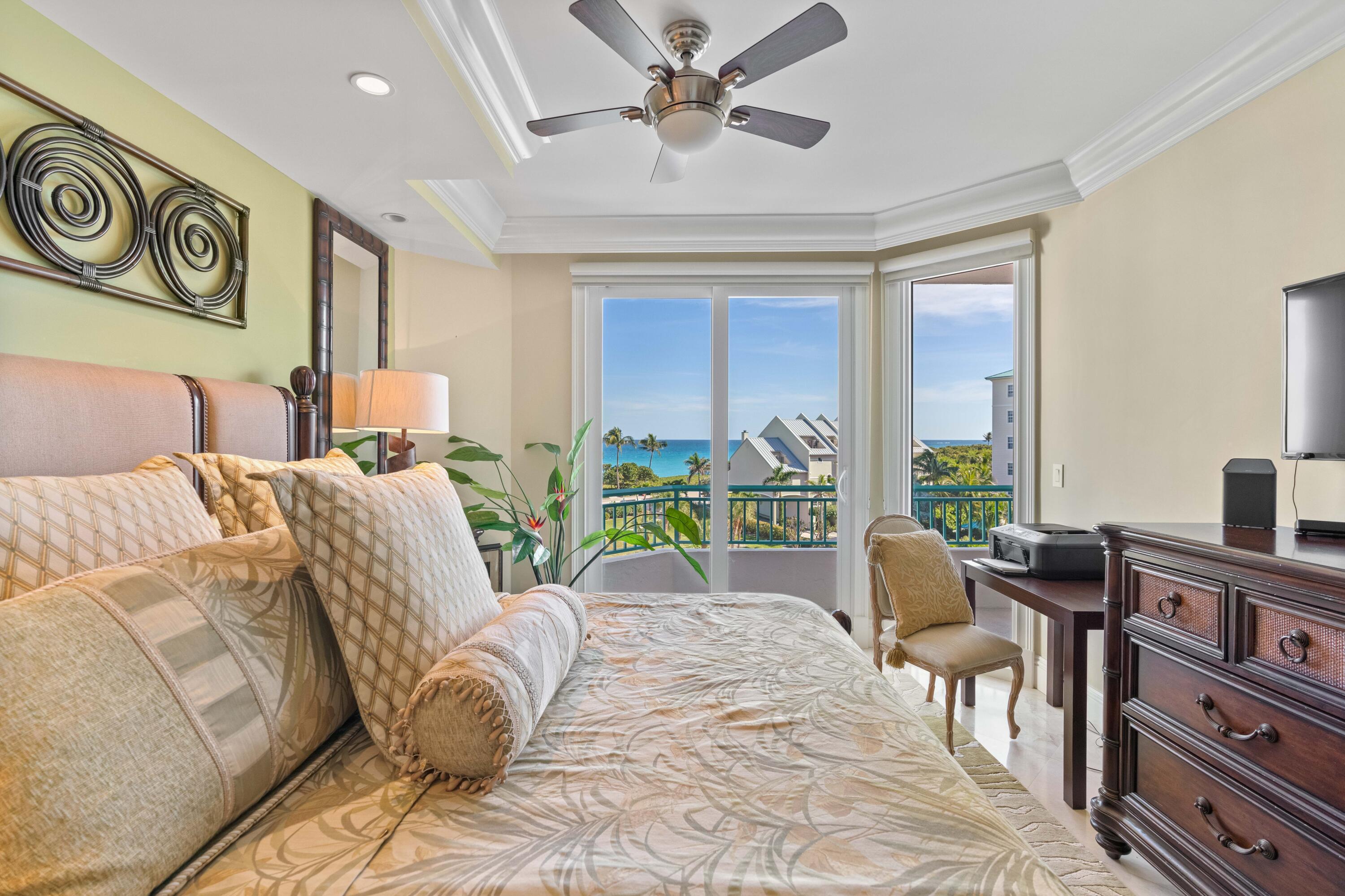 2000 Florida A1A, Unit 406 Jupiter, FL 33477 - Photo 18 of 40 a bed room with furniture and floor to ceiling window