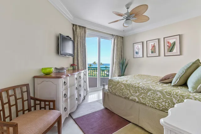 a bedroom with a bed and dresser with mirror