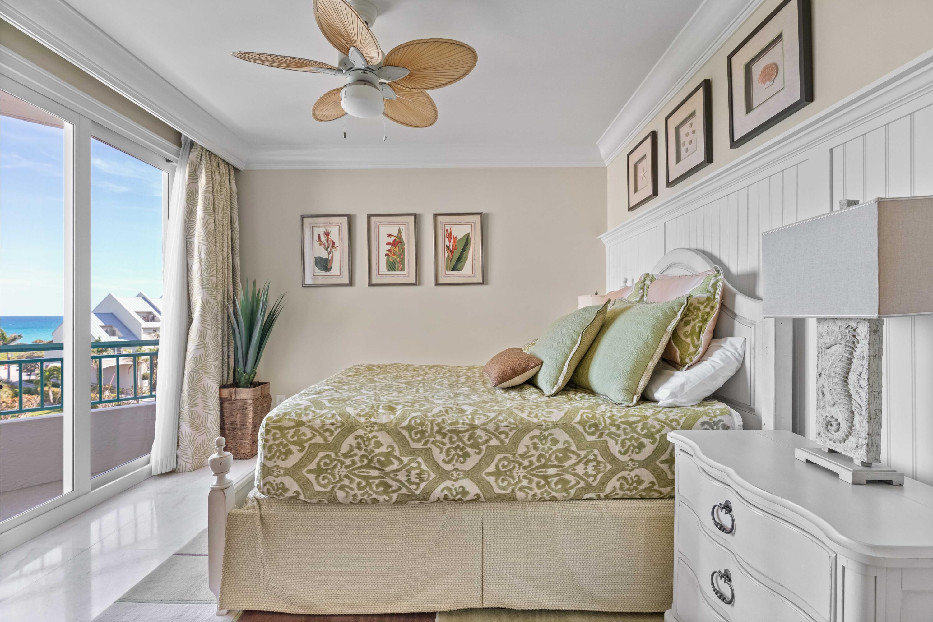 2000 Florida A1A, Unit 406 Jupiter, FL 33477 - Photo 21 of 40 a bedroom with a bed and dresser with mirror