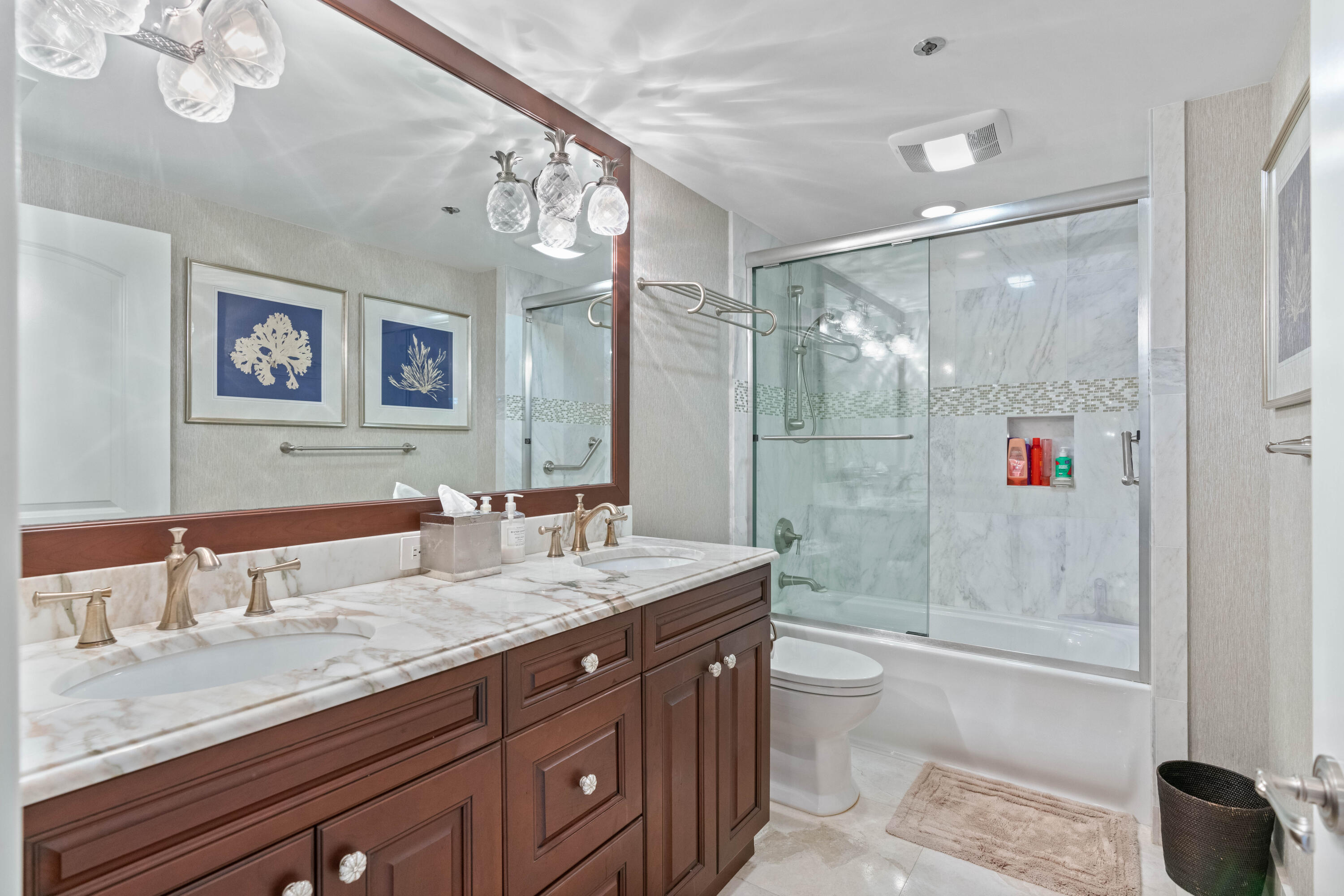2000 Florida A1A, Unit 406 Jupiter, FL 33477 - Photo 22 of 40 a bathroom with a granite countertop sink a toilet a shower and a mirror